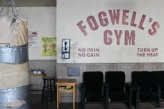 there is a gym with chairs and a sign on the wall that says powell's gym