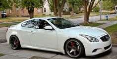 a white sports car parked on the street