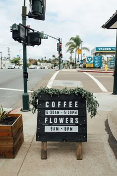 a sign that is sitting on the side of a road next to a traffic light