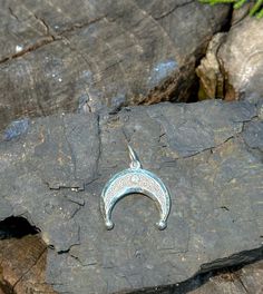 This exquisite Enamel Lunar Amulet, known as Lunnitsa or Lunula, is a symbol of ancient protection and feminine power. Crafted from high-quality silver and featuring delicate enamel detailing, this moon-shaped talisman is believed to bring good fortune, fertility, and protection to its wearer. Historically worn by women in Slavic and Baltic cultures, the Lunula pendant is a timeless piece of lunar-inspired jewelry, perfect for those seeking a deeper connection with the moon's mystic energy. Ideal for lovers of ancient symbolism, mythology, or unique handcrafted jewelry. Silver Amulet Jewelry With Moon Charm, Adjustable Moon Charm Amulet Jewelry, Silver Crescent Bohemian Jewelry, Silver Jewelry With Moon Charm For Festivals, Bohemian Silver Crescent Jewelry, Traditional Silver Crescent Jewelry, Good Luck Moon Charm Pendant Jewelry, Symbolic Jewelry With Moon Phase For Festival, Spiritual Crescent Engraved Jewelry