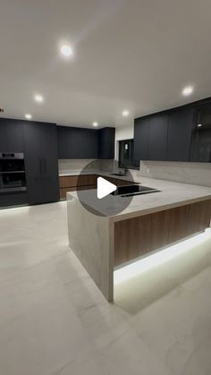 an empty kitchen with black cabinets and white counter tops, is shown in this image