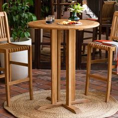 an outdoor table with two chairs around it