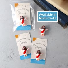 three magnets in the shape of jesus on a card and some other magnets