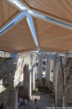 an aerial view of the inside of a building with wood shinnings and stone walls