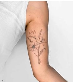 a woman's arm with flowers on it