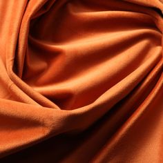 an orange colored fabric with very thin folds