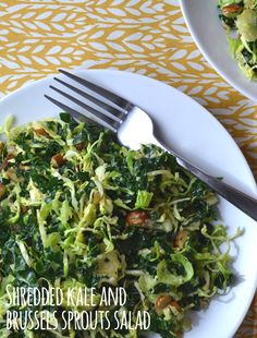 shredded kale and brussels sprouts salad on a white plate with a fork