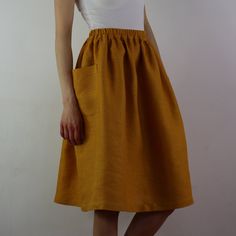 "Write the selected color in the message Handmade mustard linen midi skirt with зatch pockets on the sides, elastic waistband, perfect for casual wear and suitable for any occasion in any season Details: - 100% natural linen produced in Europe ; - medium weight (180 gram per square meter); - color: mustard, could be any from our colors catalog (color samples at the photo); Made to order, approximately a few days, If you have any questions please message me and I will be glad to answer. Size guid Summer Linen Midi-length Bottoms, Beige Skirt With Side Pockets For Summer, Beige Summer Skirt With Side Pockets, Summer Beige Skirt With Side Pockets, Chic Yellow Skirt With Elastic Waistband, Solid Linen Summer Skirt, Solid Linen Skirt For Summer, Linen Skirt With Elastic Waistband For Day Out, Casual Linen Midi Skirt