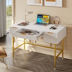 a laptop computer sitting on top of a white desk in front of a large window