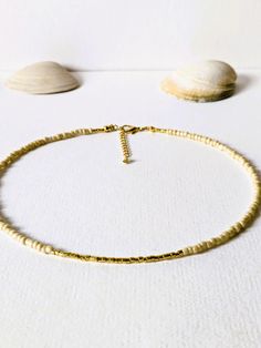 Pretty necklace with beige slightly shimmering rocailles beads (3 mm) and gold plated miyuki beads (2 mm). The necklace is 41,5 cm long and can be extended to 44, 5 cm The clasp as well as the extension chain are gold plated. The 14 carat gold filling is about 100 times thicker than simple gold plating. The gold layer is mechanically bonded to the basic brass material. The necklace is wonderful to wear together with other fine necklaces from my store. Other beautiful jewelry can be found here: https://www.etsy.com/de/shop/MerlesSchmuckArt Small inclusions, color variations and irregularities in the beads or even the metals are part of the peculiarity of the materials. Your purchased item will be sent to your home wrapped in tissue paper and a wine red organza bag. If you have any special r Gold Heishi Beaded Chain Jewelry, Adjustable Gold Heishi Beads Necklace, Gold Jewelry With Heishi Beads And Beaded Chain, Handmade Minimalist Gold Beads, Minimalist Gold Beaded Chain, Minimalist Gold Beaded Necklaces With Tiny Beads, Minimalist Gold Beaded Necklace With Colorful Beads, Adjustable Gold Pearl Necklace With Gold Beads, Adjustable Gold Beaded Pearl Necklace