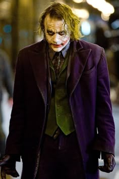 the joker is walking down the street at night