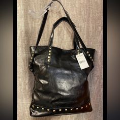 Steve Madden Black Gold Studded Handbag Tote Faux Leather Shoulder Bag. Great Bag To Carry Picnic Items Or Go To The Beach - Fancy Gym Bag Or Travel Luggage. The Interior Of The Bag Is 100% Cotton With A Black And White Herringbone Print. The Tote Measures 17” High, 17” Deep, 5” Wide, 8” Shoulder Drop And Has Carry Handles Also. Brand New With Tags! Fast Shipping! Fancy Gym, Slouchy Purse, Picnic Items, Tan Leather Handbags, Studded Handbag, Steve Madden Purse, Suede Purse, White Herringbone, Over The Shoulder Bags