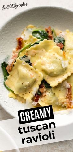 a white bowl filled with pasta and spinach