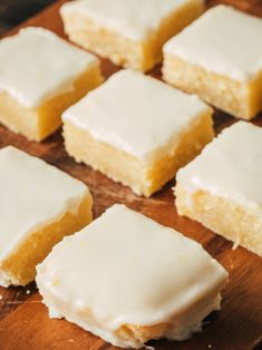 several pieces of cake sitting on top of a wooden cutting board