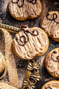 some cookies with icing and chocolate are on a table