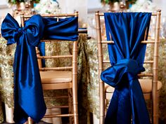 the chairs are covered with blue satin ribbons