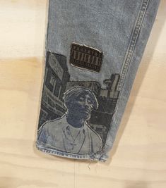 a pair of jeans with a drawing of a man on it