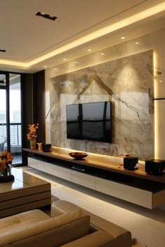 a living room with a large television mounted on the wall