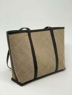 Upgrade your accessory game with our stylish rattan tote bag featuring genuine leather accents. Perfect for adding a touch of boho chic to any outfit! Free shipping worldwide. Color: Natural/black leather Material: Rattan/Cow leather Handle drop: 10.5" Height: 11.5" Width: top 17", bottom 14.25" Depth: 4" Lined, snap button closure with leather details. Sewing the classic rattan cane in a 45-degree angle brings a contemporary touch to this modern tote, resulting in a sharp and polished aesthetic Chic Bucket Bag With Leather Trim, Everyday Leather Woven Bag, Woven Leather Bags For Everyday Use, Everyday Leather Woven Shoulder Bag, Chic Black Bag With Leather Trim, Elegant Everyday Leather Straw Bag, Chic Black Satchel With Leather Trim, Chic Natural Leather Bucket Bag, Everyday Rectangular Woven Leather Bucket Bag