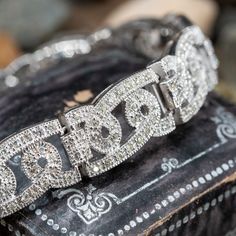 This captivating bracelet is bordered with milgrain edging and is accented with three hundred thirty-six (336), bead set, round brilliant cut diamonds. The bracelet measures 10.0mm wide, 3.7mm thick and an overall length of 7 inches. The bracelet is finished with a hidden box clasp. Classic Diamond Pave Bangle Bracelet, Luxury Diamond Bracelet With Pave Setting, Diamond Bracelet With Pave Setting For Anniversary, Luxury Round Cut Diamond Bracelet With Pave Setting, Luxury Diamond Bracelet With Intricate Design, Luxury Platinum Bracelet With Pave Setting, Classic White Gold Diamond Bracelet With Pave Setting, Art Deco White Gold Jubilee Diamond Bracelet, Luxury Diamond Bracelet With Pave Setting For Wedding