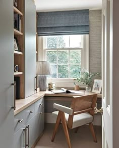 a home office with built - in desk and bookcases, along with a chair