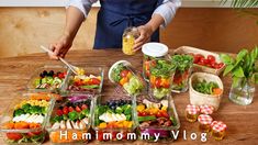 a woman in an apron is making a salad with vegetables and dressing on the table