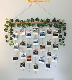 a laptop computer sitting on top of a desk next to a wall hanging with photos