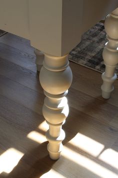 an image of a table that is in the middle of some wood flooring with sunlight coming through it