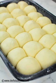 a pan filled with dough sitting on top of a counter