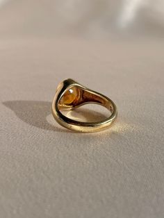 10k yellow gold signet ring by 23carat featuring a beautiful faceted citrine in a bezel setting. Excellent condition Size: 6.75 resizable* Weight: 5.7 grams Band: 11.0 mm (front), 3.0 mm (back) Citrine: 9.0 mm x 8.0 mm oval cut Hallmarks: 10k, water barrel and heart for 23carat Handmade to order, please allow for approximately 1 to 3 weeks before shipping For more details or customization options, emails us at info@shop23carat.com Water Barrel, Gold Signet Ring, Oval Cut, Bezel Setting, Signet Ring, Citrine, Barrel, Silver Rings, Yellow Gold