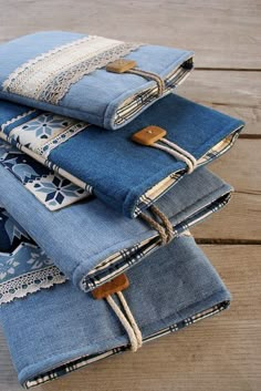 several pairs of jeans stacked on top of each other