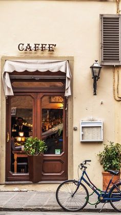 a blue bicycle parked in front of a cafe