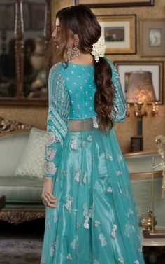 Verdigris full-sleeved Pishwas in chiffon with a leaf neckline, paired with a matching tissue sharara. Discover long Anarkali dresses, festive Anarkali suits, and elegant options for bridesmaids.Witness the enchanting beauty of the verdigris festive ensemble, a visual symphony that resonates with the soul and dances to a captivating folk melody. Adorned with intricate silver embellishments, this attire breathes life into the essence of tradition, exuding an exquisite charm that captivates the be Frock Pakistani, Tissue Sharara, Bridal Frock, Long Anarkali Dress, Pakistani Bridal Dress, Anarkali Dresses, Long Anarkali, Ice Blue Color, Pakistani Dresses Online