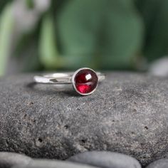 Garnet symbolizes love and is the gemstone to give for the 2nd anniversary. It is also the birthstone for January. This simple sterling silver stacking ring is a great gift, or an addition to a collection of stacking rings. Here are the details: This ring is made with a 4mm or 5-6mm bezel set garnet cabochon set on a sturdy sterling silver band handmade in your size. It can be worn with other stackable rings, or by itself.Please select your ring size. Sizes are US based. Stackable Sterling Silver Rings For May Birthstone, Fine Jewelry Sterling Silver Stackable May Birthstone Rings, Sterling Silver Stackable Rings For Anniversary - May Birthstone, Classic Ruby Stackable Rings As A Gift, Classic Ruby Stackable Rings For Gift, Sterling Silver Stackable Rings For Anniversary, May Birthstone, Sterling Silver Stackable Rings, May Birthstone Gift, Minimalist Sterling Silver Solitaire Ruby Ring, Minimalist Solitaire Ruby Ring In Sterling Silver