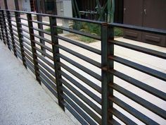 a metal fence on the side of a building