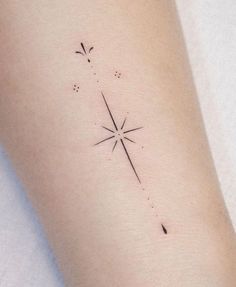 a woman's arm with a star tattoo on it