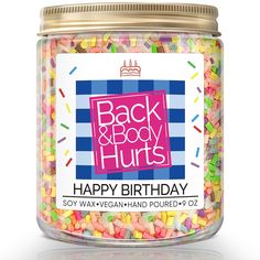 a jar filled with lots of sprinkles next to a sign that says back and body hurts