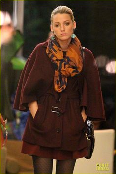 a woman is walking down the runway with her hand on her hip while wearing black tights