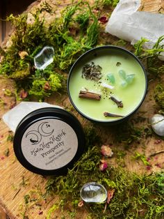 an image of a candle and some herbs on a table