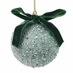 a christmas ornament with a green bow hanging from it's front end