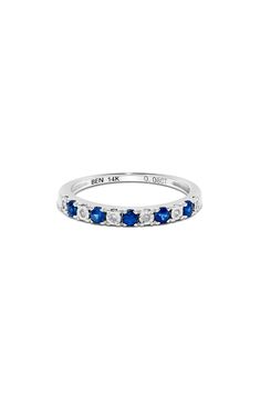 a white gold ring with blue sapphire stones