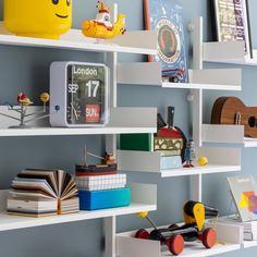 shelves with books and toys on them in a children's playroom or bedroom