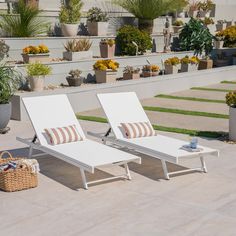 two white lounge chairs sitting next to each other