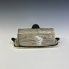 a black and white striped purse on a plate