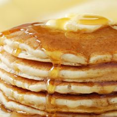 a stack of pancakes covered in syrup and butter