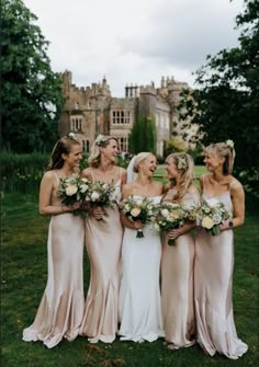 a group of women standing next to each other on top of a lush green field