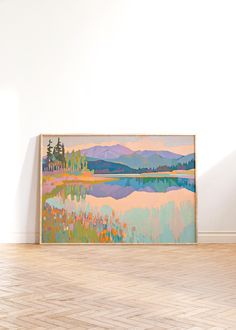 a painting is hanging on the wall in an empty room with hard wood flooring