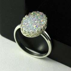 This stunning and sparkly ring includes white natural Druzy Quartz gemstone set on Sterling Silver oval bezel mounting. RING DESCRIPTION: ♦ RING MATERIAL: Sterling Silver ♦ GEMSTONE: Natural Druzy Quartz ♦ STONE COLOR: White ♦ STONE GRADE: A ♦ STONE SHAPE: Oval ♦ STONE DIMENSION: 14x10 mm The ring comes in a nice gift box as featured in the picture #5. It is ready for gift giving! ☛Please select your desired ring size from Size dropdown when ordering☚ View all of my Druzy rings: ► http://www.ets Ring Everyday, Sparkly Ring, Druzy Quartz, April Birthstone, Oval Stone, White Stone, Quartz Stone, Ring Silver, Druzy Ring