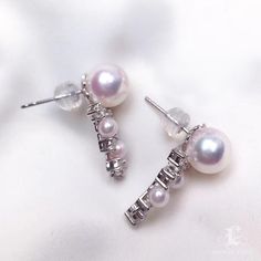 This is a very beautiful and delicate earring. The highest quality in world pearl jewelry. Product Information Origin Japan Material Akoya Pearls, 18k White Gold, and Natural Diamonds DimensionsHeight Approx. 2.5 cm Pearl Shaped: Round Size: 4-5mm and 8-8.5mm Quality: AAA Nacre: Very Thick Color: White Luster: Very High Accessories Metal: 2.6g of 18K White Gold Other: 0.60ct of SI Quality Natural Diamond Including With Your Purchase: 30-Day Money-Back Guarantee Company Certificate Exquisite Gift Luxury Pearl Pendant Earrings As Gift, Fine Jewelry Pearl Earrings For Anniversary, Fine Jewelry Pearl Earrings In Diamond White, Luxury Round Pearl Drop Earrings, Timeless Silver Akoya Pearl Earrings, Luxury Pearl White Dangle Pearl Earrings, Diamond White Pearl Earrings Fine Jewelry, Sterling Silver Pearl Earrings Fine Jewelry, Luxury Pearl Charm Earrings As Gift