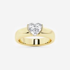 a yellow gold ring with a heart shaped diamond in the center, on a white background